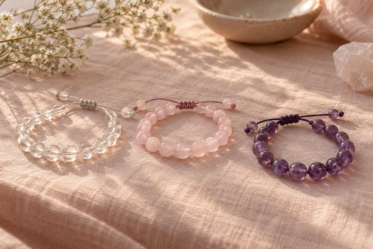 Everyday crystal thread bracelets arranged on blush linen.