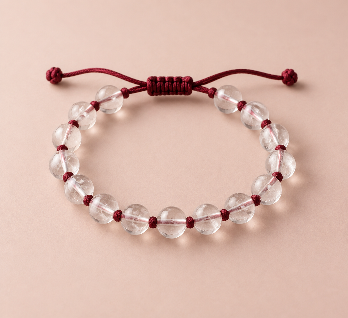 Clear quartz beads on a hand-knotted burgundy silk cord.